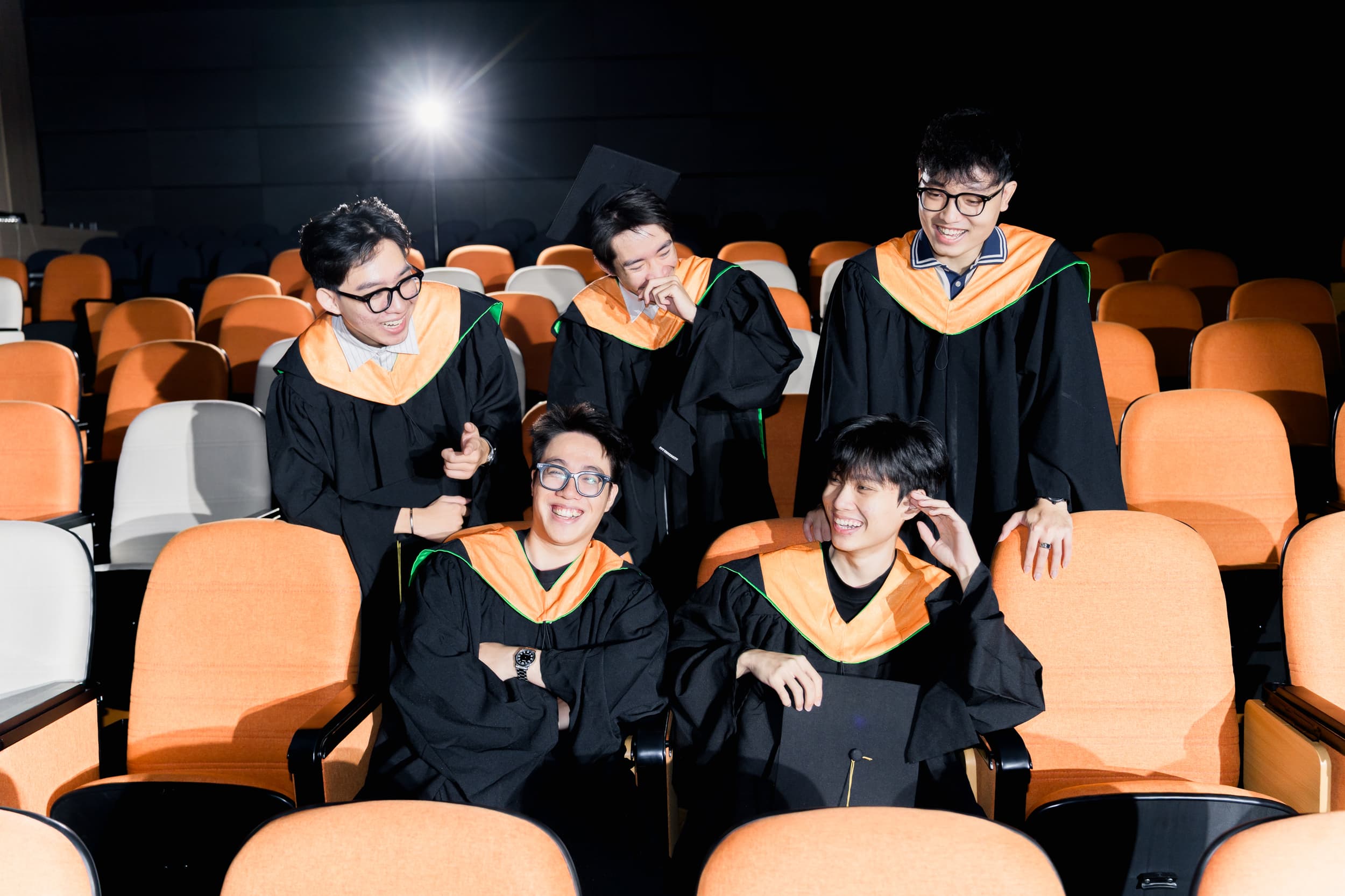 Graduates celebrating together in the auditorium
