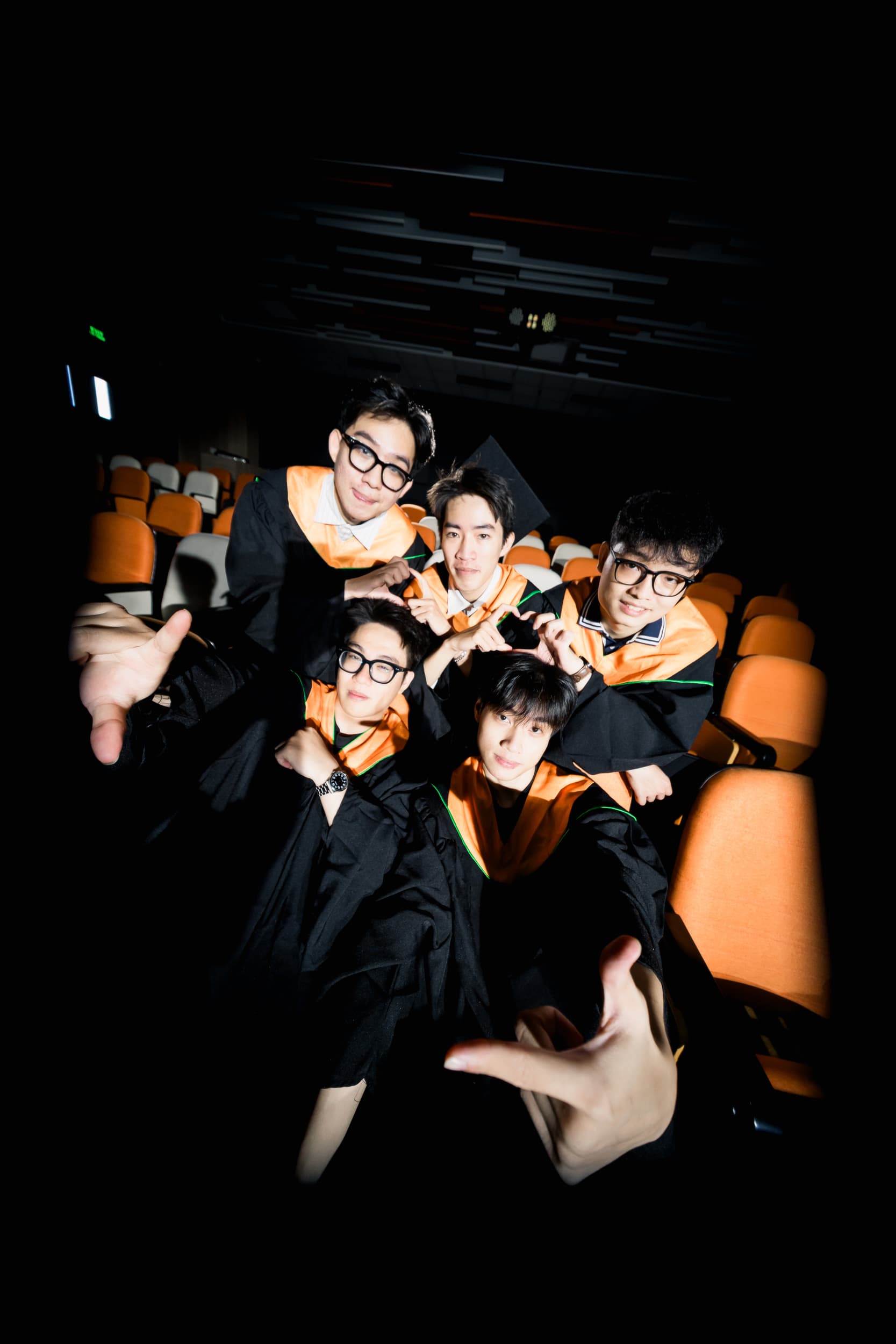 Graduates celebrating together in the auditorium